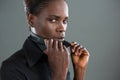 Androgynous man holding shirt collar against grey background Royalty Free Stock Photo