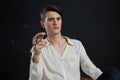 Androgynous man posing while holding spectacles Royalty Free Stock Photo