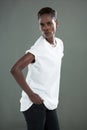 Androgynous man in white top posing against grey background Royalty Free Stock Photo