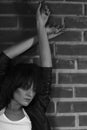 Androgyny female model in Heroin chic style near brick wall. Royalty Free Stock Photo