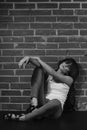 Androgyny female model in Heroin chic style near brick wall. Royalty Free Stock Photo