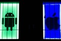 Android and Apple logotype on pc screen. Android - the operating system. Apple is an corporation, that develops, and sells