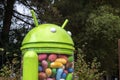 Android jelly bean statue with trees in background in garden at google campus