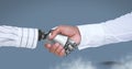 Android Robot hand shaking businessman hand with blue background Royalty Free Stock Photo