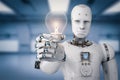 Android robot holding light bulb Royalty Free Stock Photo