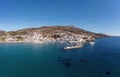 Andros island Batsi Cyclades Greece. Aerial drone view of port boat, building, sandy beach sea sky Royalty Free Stock Photo