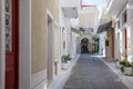 Andros island, Chora town, Cyclades Greece. Paved alley, house wall, souvenir shop Greek art Royalty Free Stock Photo