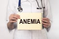 Anemia word on paper in doctor hand