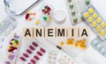 ANEMIA word written on building blocks. Pills and stethoscope background. Medical concept