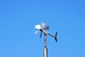 Anemometer wind speed indicator measuring device under blue sky and clouds Royalty Free Stock Photo