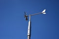 Anemometer wind speed indicator measuring device under blue sky and clouds Royalty Free Stock Photo