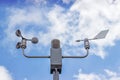 Anemometer and wind vane on blue sky