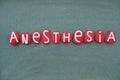 Anesthesia, medical term composed with red colored stone letters over green sand