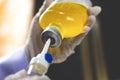 Anesthesiologist Doctors hand inject I.V. drip set into normal saline solution NSS bottle