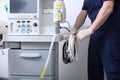 The anesthesiologist-resuscitator connects the device for artificial ventilation of the lungs. Preparation for surgery