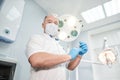 An anesthetist doctor holds a syringe in his hands and looks into the frame Royalty Free Stock Photo