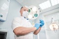 An anesthetist doctor holds a syringe in his hands and looks into the frame Royalty Free Stock Photo