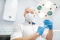 An anesthetist doctor holds a syringe in his hands and looks into the frame Royalty Free Stock Photo