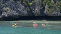 ANG THONG MARINE PARK, SAMUI, THAILAND - 9 JUNE 2019: People kayaking near cliff in paradise sea. Group of tourists paddling while Royalty Free Stock Photo