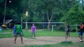 ANG THONG, THAILAND - 9 JUNE 2019: Thai teenagers playing sepak takraw in park. Group of men playing kick volleyball against green