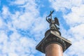 Angel on the Alexandrian pillar in St. Petersburg against the blue sky with white clouds. Royalty Free Stock Photo