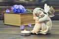 Angel, burning candle and hyacinth flower on the book Royalty Free Stock Photo