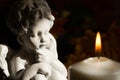 Angel and burning candle on dark background Royalty Free Stock Photo