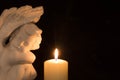 Angel and candle on dark background Royalty Free Stock Photo