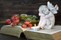 Angel, candle and dry roses Royalty Free Stock Photo