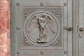 Angel carving on church doors in Berlin, Germany. Detail of the metallic panel on the temple doorway, entrance to the church