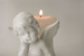 Angel figure with burning candles