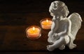 Angel figurine with burning candles Royalty Free Stock Photo