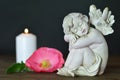 Angel, flower and candle on wooden background Royalty Free Stock Photo