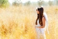 Angel girl in golden field with white wings Royalty Free Stock Photo