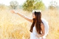 Angel girl in golden field with white wings Royalty Free Stock Photo