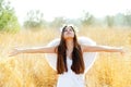 Angel girl in golden field with white wings Royalty Free Stock Photo