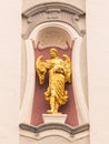 Angel golden statue on the facade of a church.