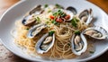 Angel Hair pasta with oysters and bean sprouts in a white enamel plate on a wooden surface.