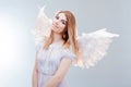 An angel from heaven. Young, wonderful blonde girl in the image of an angel with white wings. Royalty Free Stock Photo