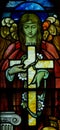 An angel holding a cross in stained glass