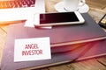 Angel Investor on business card in office setting