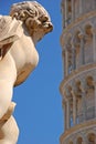 An angel of La Fontana dei Putti with slight view of Leaning Tower of Pisa