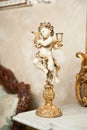 Angel with lyre ornament. Golden ornament. Vintage angel. Ceramic angel playing harp. Cupid as candle holder on marble Royalty Free Stock Photo