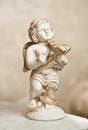 Angel with lyre, ornament. Golden ornament. Vintage angel. Ceramic angel playing harp. Cupid statuette on marble. Royalty Free Stock Photo