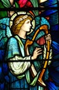 An angel making music in stained glass