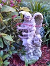 Angel playing harp in a garden