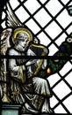 An angel playing on a harp (making music) in stained glass