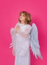 Angel prayer. Angel child. Isolated studio shot. Cute kid with angel wings. Cupid with prayer hands, hope and pray Royalty Free Stock Photo