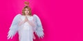 Angel prayer. Child at angel costume with prayer hands, hope and pray concept. Wide banner panoramic header copyspace Royalty Free Stock Photo