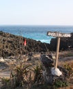 Angel`s Billabong sign with view of rock cliffs and ocean at Nusa Penida, Indonesia